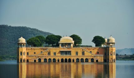 Beautiful view of Jal Mahal Palace in Rajasthan, India surrounded by water and nature.